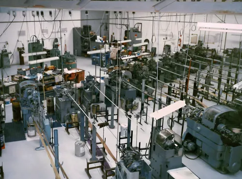 A large shop floor featuring an array of lathes and machinery in the 1980s, highlighting a dynamic shop floor atmosphere.