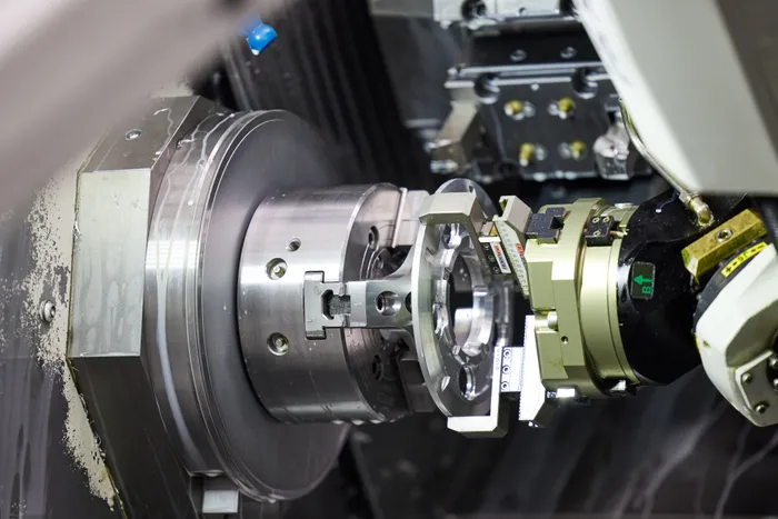 A robotic arm is seen unloading components from a CNC lathe, illustrating the integration of automation in industrial processes.