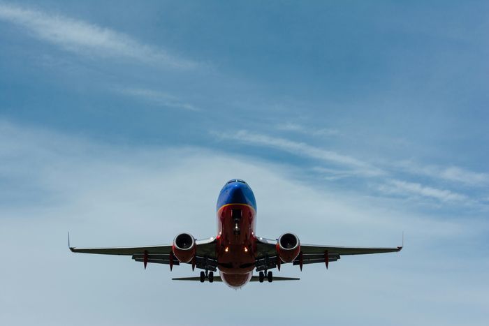 A large jet airplane soaring through a clear blue sky.