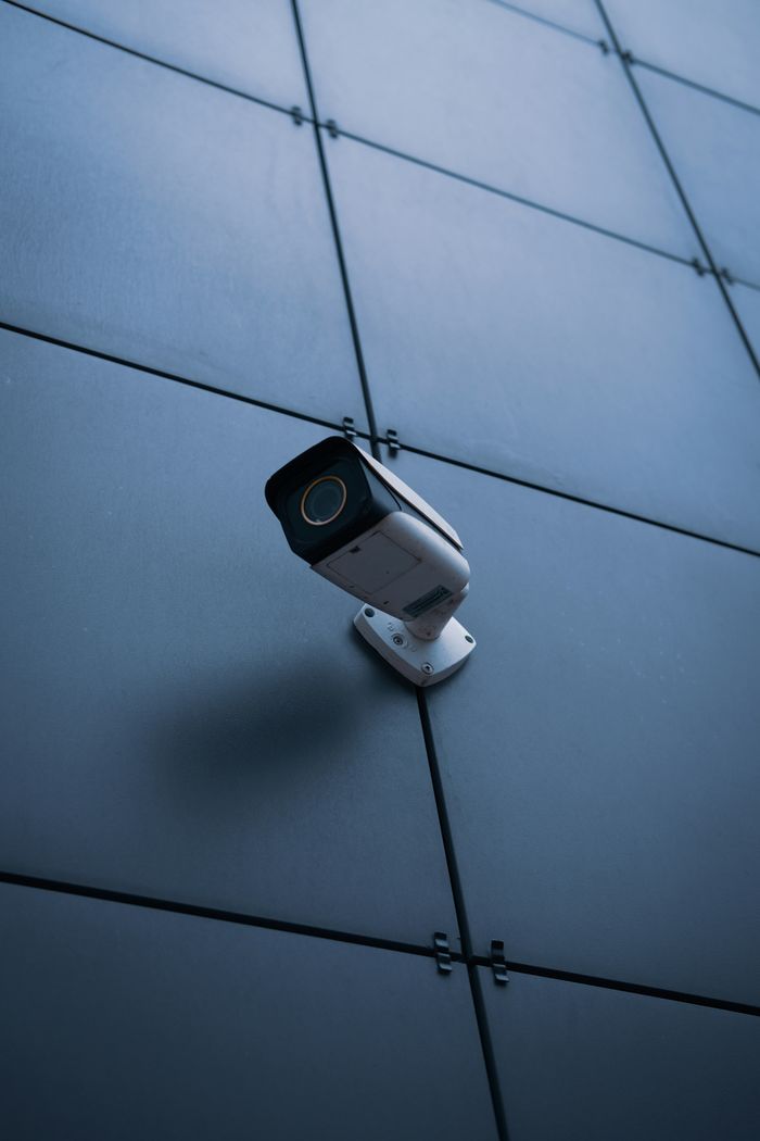 A security camera is securely mounted on a wall, monitoring the area for enhanced safety and surveillance.